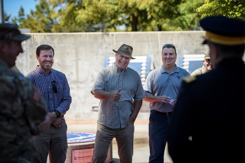 A group of people standing in a circle and smiling