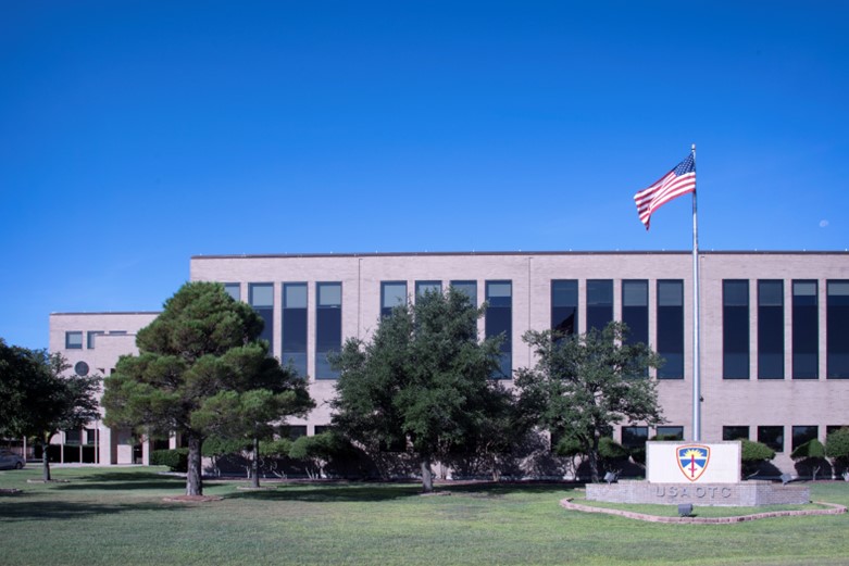 An office building with an American flag in front of it.