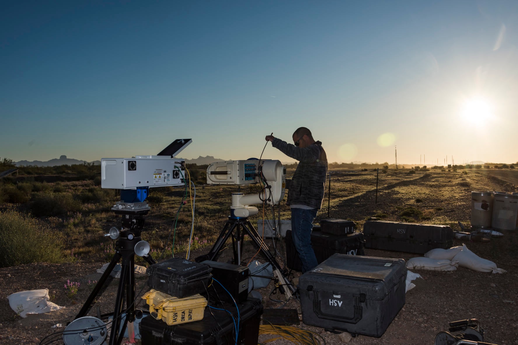 A man outdoors arranging electrical equipment